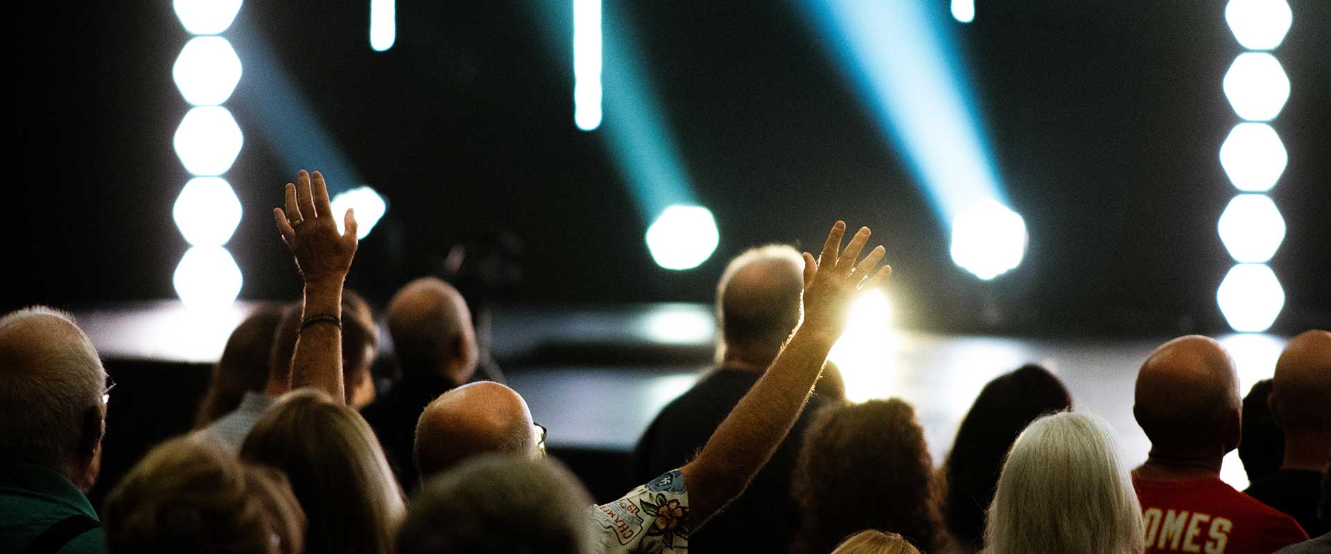 People worshiping with their hands raised